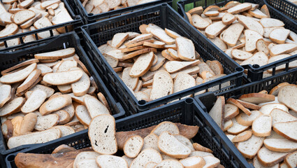 Dry bread lying in plastic crates.