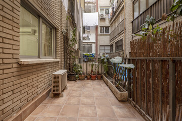 Fototapeta na wymiar Terrace of a house on the ground floor in the inner courtyard of an urban residential building