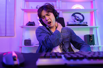 Asian Gamer Grab His Shoulder Muscle with Pain After Playing Game For a Long Time © charnsitr