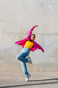 Young dancer hip hop dancing on footpath