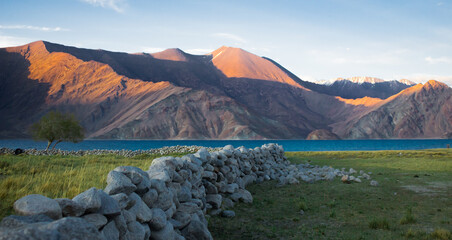View of pangong lake from merak village in ladakh. himalayan mountains in distance.