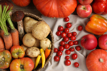 Different fresh ripe vegetables and fruits on wooden table, flat lay