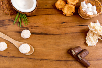 Coconut sweets on a wooden table, coconut, coconut candy, chocolate coconut, cocada and beijinho