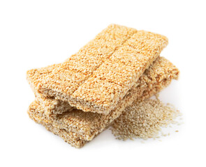 Delicious sweet kozinaki bars and sesame seeds on white background