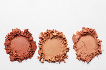 Different crushed eye shadows on white background, top view