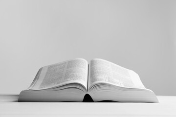 Open Bible on white wooden table, space for text. Religious book