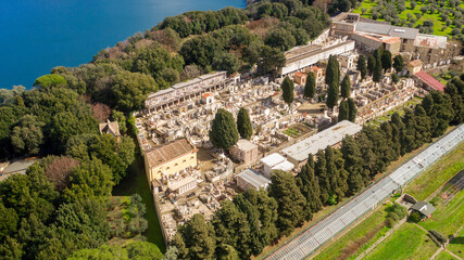 Obraz premium Aerial view of the cemetery in Albano Laziale, Italy. It is a small cemetery with the graves of the villagers. It is located in front of the Albano lake, a volcanic crater lake. 