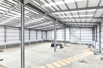 construction site of commercial warehouse building showing various materials and frame of building - 576032811