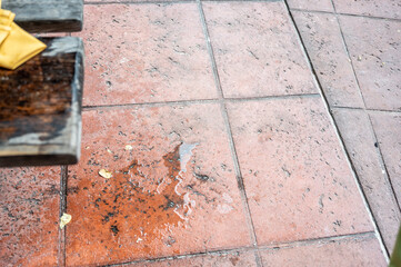 Spilled drink on a wooden picnic bench.