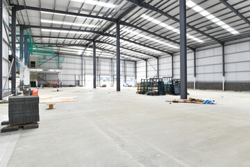 construction site of commercial warehouse building showing various materials and frame of building - 576033009