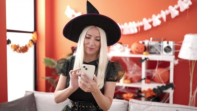 Young blonde woman make selfie by smartphone having halloween party at home