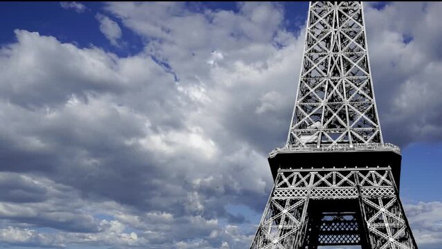 Eiffel Tower in Paris, France (against the background of moving clouds, time lapse, with zoom)