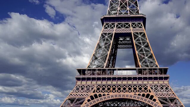 Eiffel Tower in Paris, France (against the background of moving clouds, time lapse, with zoom)