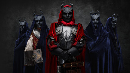 Portrait of secret cult and its members dressed in robes and dark masks.