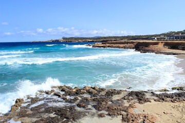 Fototapeta na wymiar The paradisiacal beach of Cala Bassa in Ibiza in the Balearic Islands. Fantastic blue and turquoise sea and white sand beaches.