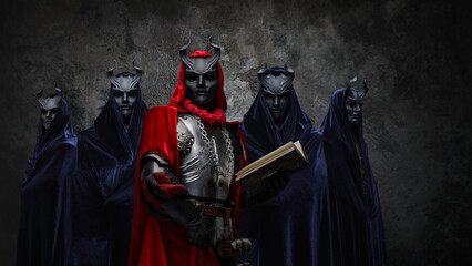 Portrait of occult brotherhood and their leader with book against dark background.