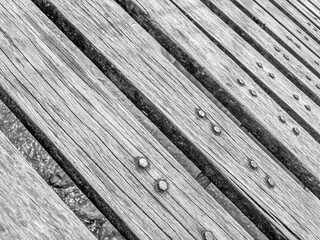 Wooden floor with rivets in black and white. Abstract background and texture for design.