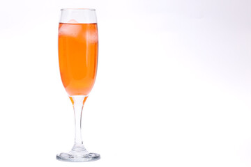 Orange liquor glass on white background.