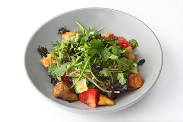 Salad with baked eggplant. Baked eggplant with arugula and tomatoes and cucumbers. Plate on a white background. Photos for the menu.