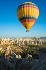 Fototapeta na wymiar Cappadocia, Hot air balloon is flying over amazing landscape, Travel destination in Turkey