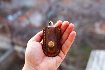 Vintage style mini size leather knife sheath in hand. Small folding knife sheath made by rustic leather. 