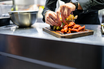 chef cookind chicken breast strips and french fries on restaurant kitchen