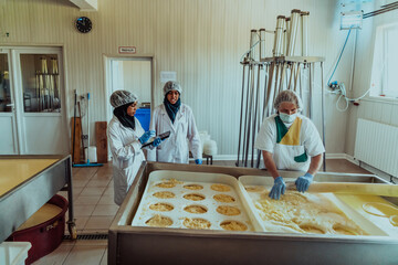 Arab business partners oversee cheese production in modern industry