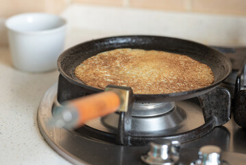 Baking pancakes in a cast iron skillet.