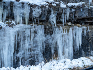 Beautiful winter panorama with fresh powder snow. Landscape with fir trees, blue sky with sunlight and high alpine mountains in the background The beautiful winter landscape with trees covered with ho