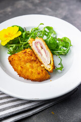cordon bleu cutlet chicken meat, cheese, bacon second course meal snack on the table copy space food background rustic top view