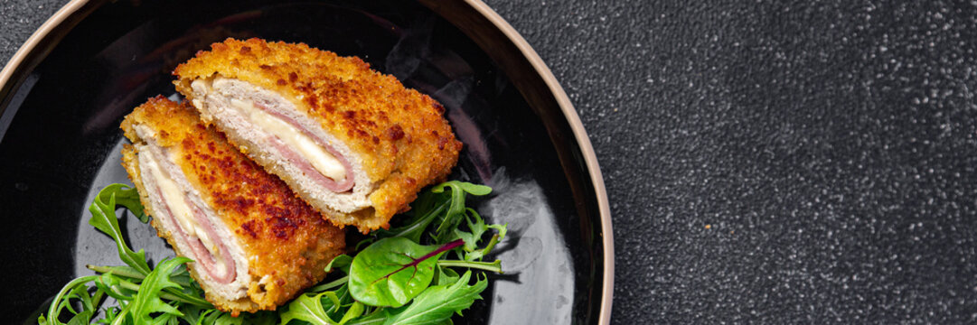 cordon bleu cutlet chicken meat, cheese, bacon second course meal snack on the table copy space food background rustic top view