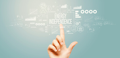 Energy Independence concept with hand pressing a button on a technology screen