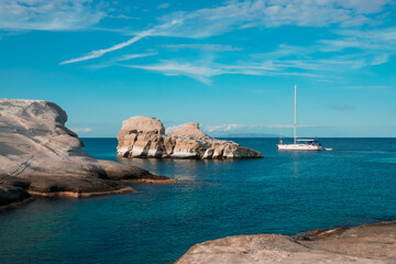 A yacht on calm Greek blue sea at Sarakiniko beach on Milos