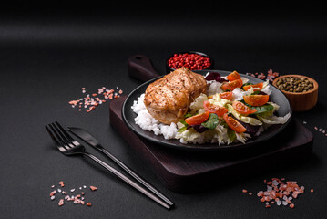 Delicious healthy breakfast consisting of chicken, rice, greens and cherry tomatoes