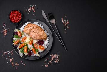 Delicious healthy breakfast consisting of chicken, rice, greens and cherry tomatoes