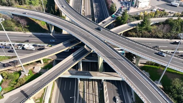 Aerial drone time lapse loop video of multilevel junction overpass highway roads during rush hour
