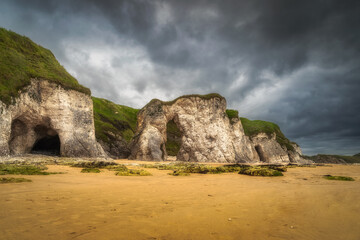 Panorama with white limestone rock formations and sandy beach on beautiful Causeway Coast and Wild...