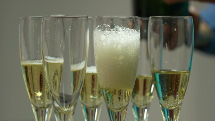 Pouring champagne. Pour the champagne into many glasses. Bartender pouring champagne into glass...