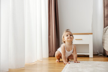 An adorable little girl is crouching and playing as she is frog.