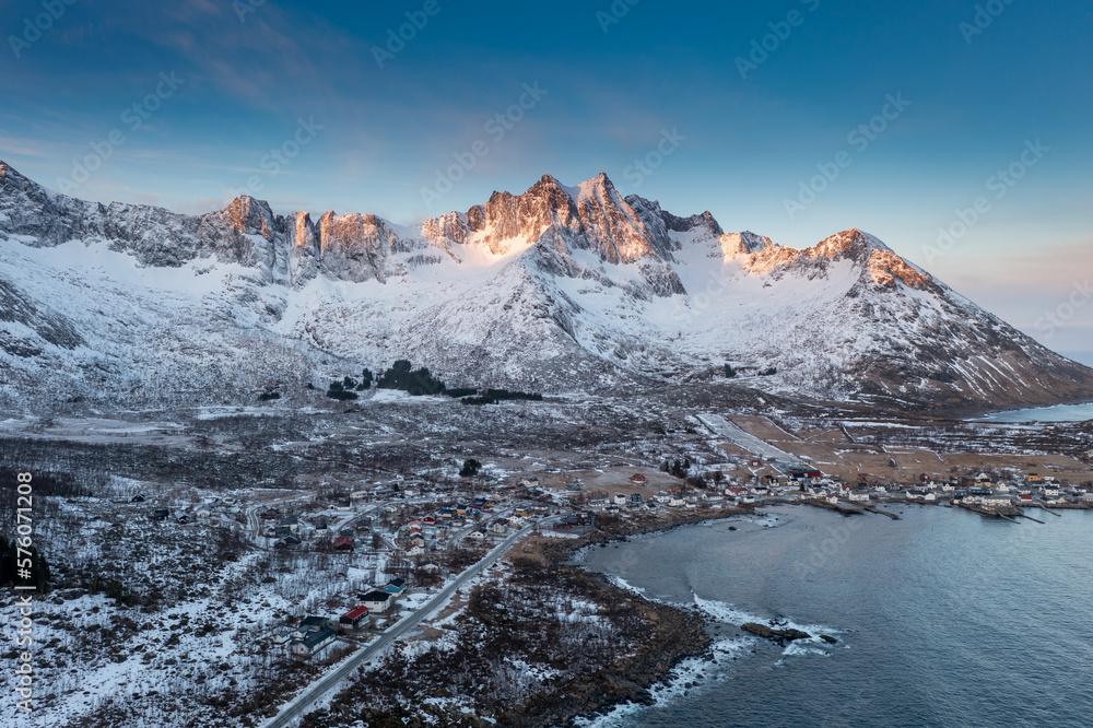 Wall mural snow covered mountain range on coastline in winter, norway. senja panoramic aerial view landscape no