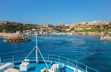 The ship arrives at the port of Mġarr on the island of Gozo, Malta. Beautiful city on the cliffs...