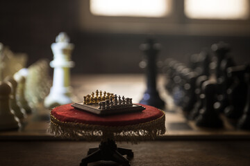 Chess board game concept of business ideas and competition and strategy ideas concep. Chess figures on a dark background with smoke and fog. Selective focus