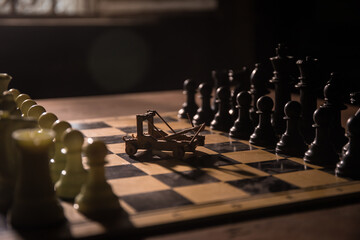 Medieval battle scene with two cannon on chessboard. Chess board game concept of business ideas and competition and strategy ideas Chess figures on a dark background with smoke and fog.