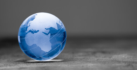 Blue world globe crystal glass on black background