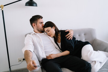Happy couple embracing each other on sofa