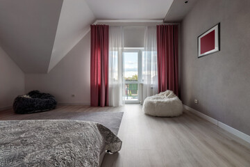 Beautiful interior design of a modern and cozy bedroom with pink pillows and curtains