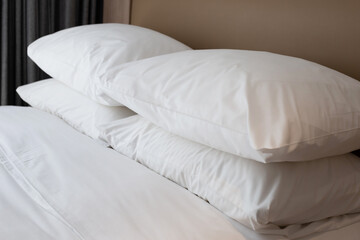 Bed with white pillows in bedroom