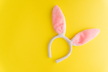 soft fur hoop with pink rabbit ears on a yellow background