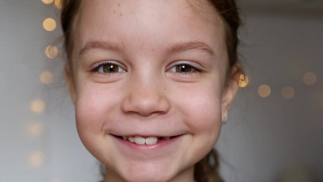 cute girl without a tooth smiles at the camera close-up. The concept of pediatric dentistry and healthy teeth
