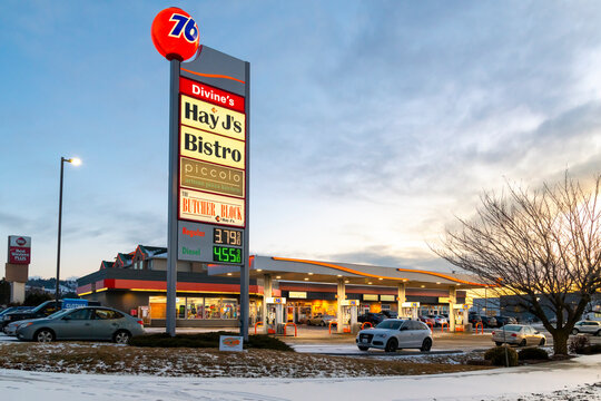 General view of a Union 76 gas and service station and shopping center with eating establishments on a winter evening with snow on the ground in Spokane, Washington, USA, on March 1 2023.